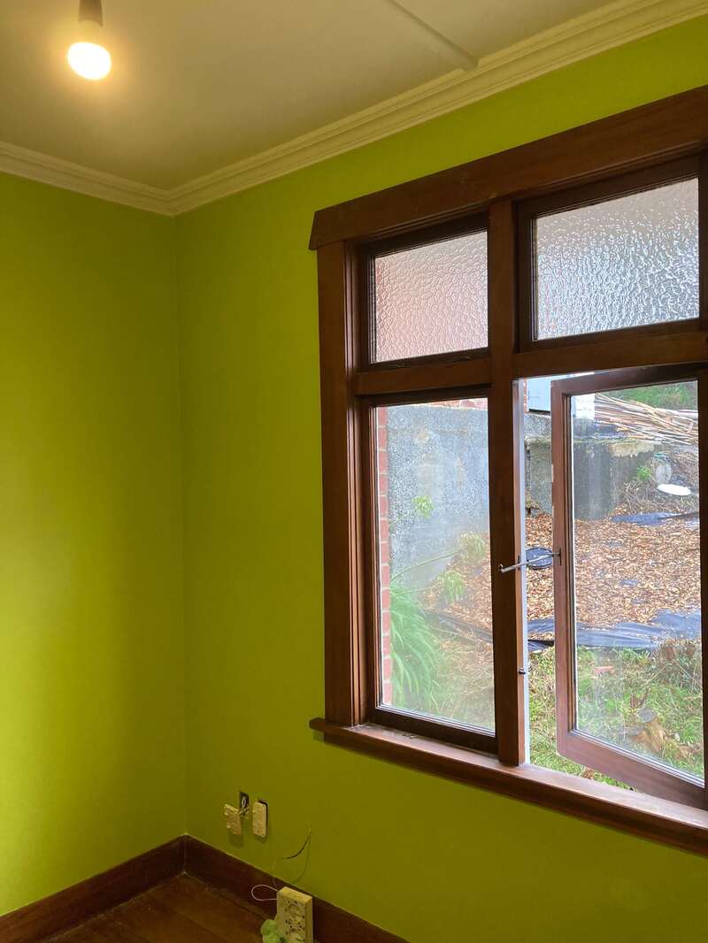 Professional interior wall painting in a vibrant green color by skilled painters